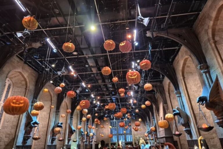 Harry Potter Halloween decorations at the Warner Bros. Studio Tour London, featuring hanging pumpkins in a Great Hall.