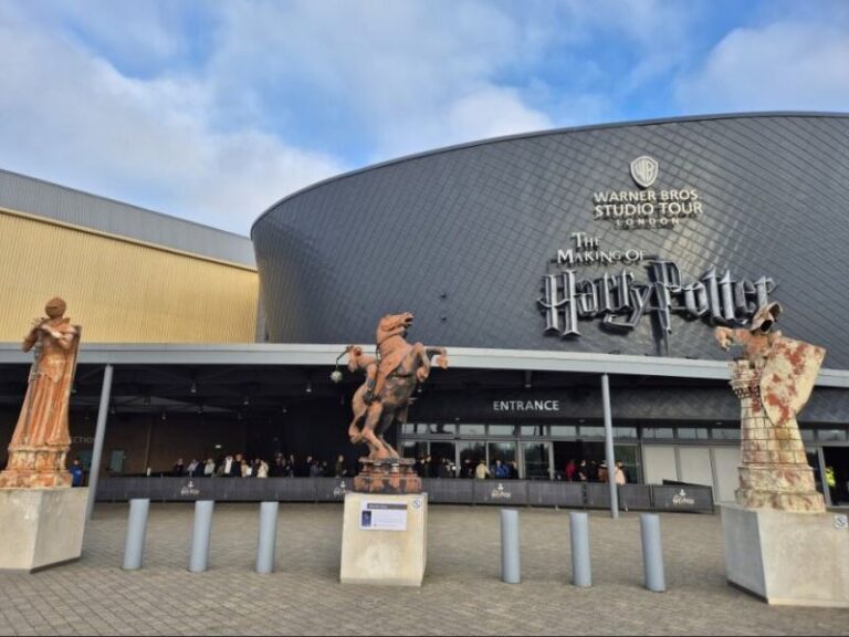 Entrance to the Warner Bros. Studio Tour London, featuring large Harry Potter chess piece statues.