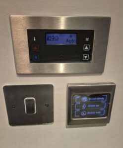 Digital control panel for adjusting room settings and temperature.