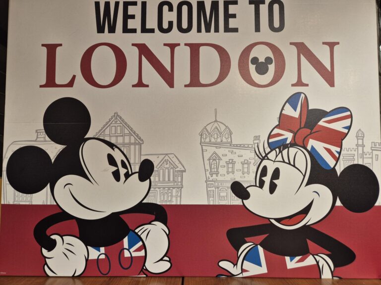 Welcome to London sign featuring Mickey Mouse and Minnie Mouse with Union Jack themed clothing and bow, with London landmarks in the background.