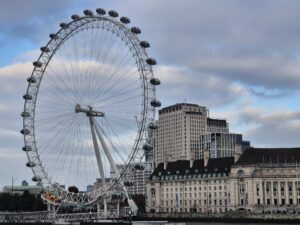 The London Eye, a large Ferris wheel, photographed during the day.