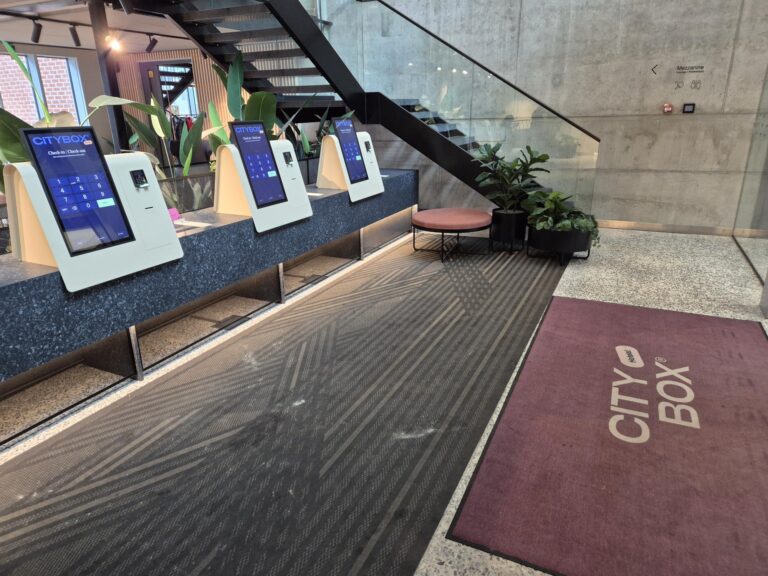 Self-service check-in and check-out area at Citybox Tallinn hotel entrance.