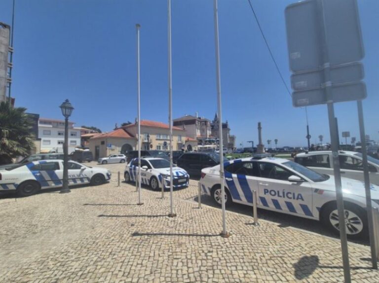 🌊 Seaside Experience: Cascais & Cabo da Roca Day Trip Highlights (2025) 5 Street view with parked police cars and buildings.