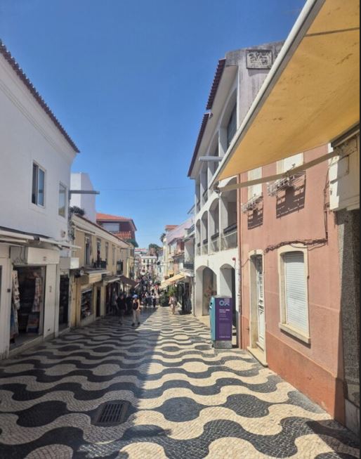 🌊 Seaside Experience: Cascais & Cabo da Roca Day Trip Highlights (2025) 7 Narrow street between buildings.