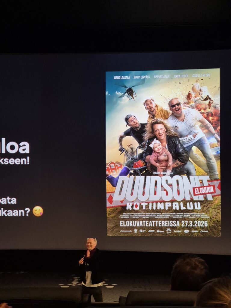 This image shows the setting of the advance screening discussed in The Dudesons homecoming movie review, highlighting the cinema environment and official movie poster ahead of the film’s release.