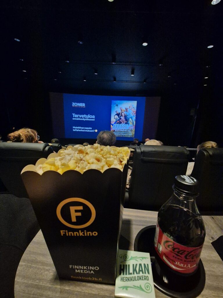 Cinema seating, snacks, and screen during The Dudesons homecoming movie review preview screening.