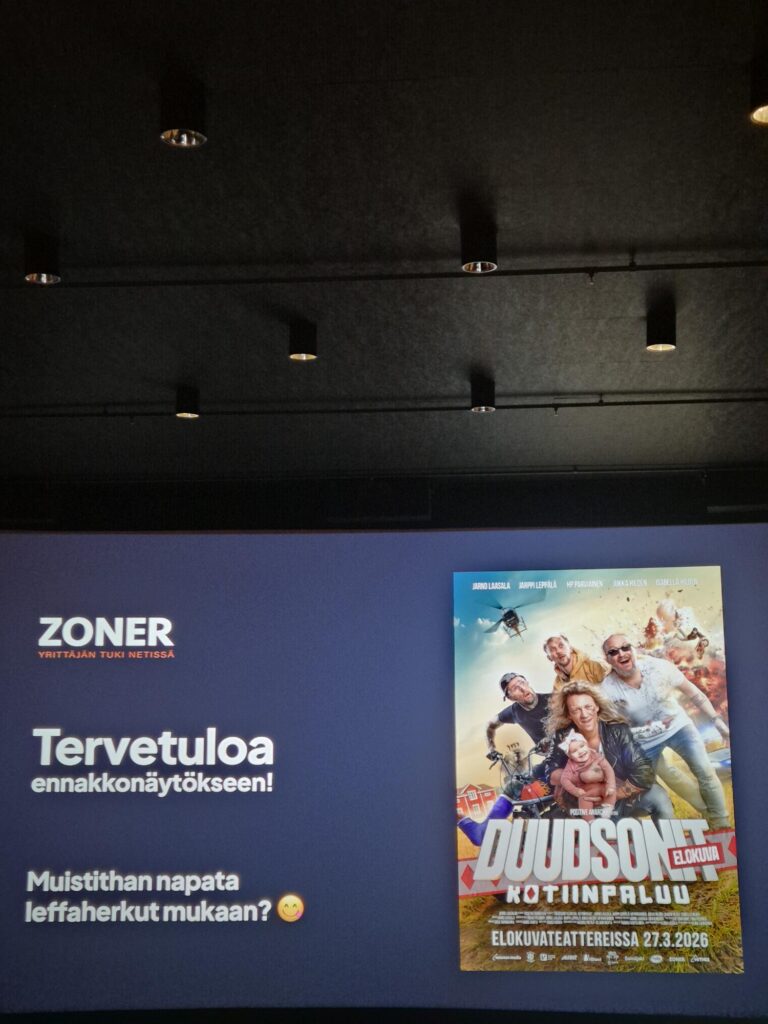 Cinema screen and poster at a preview event featured in The Dudesons homecoming movie review.