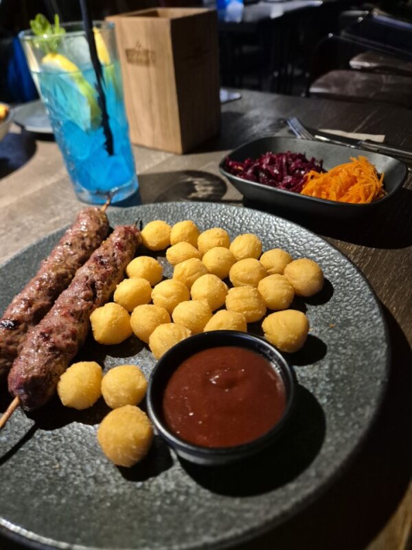 Grilled meat skewers with potato bites and sauce at Grill London in Vilnius