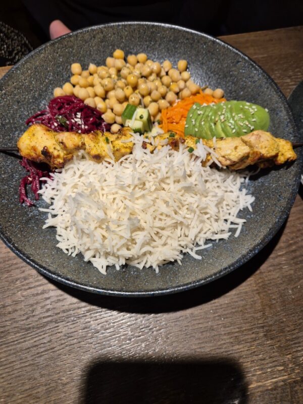 Grilled chicken bowl with rice, chickpeas, and avocado at Grill London in Vilnius
