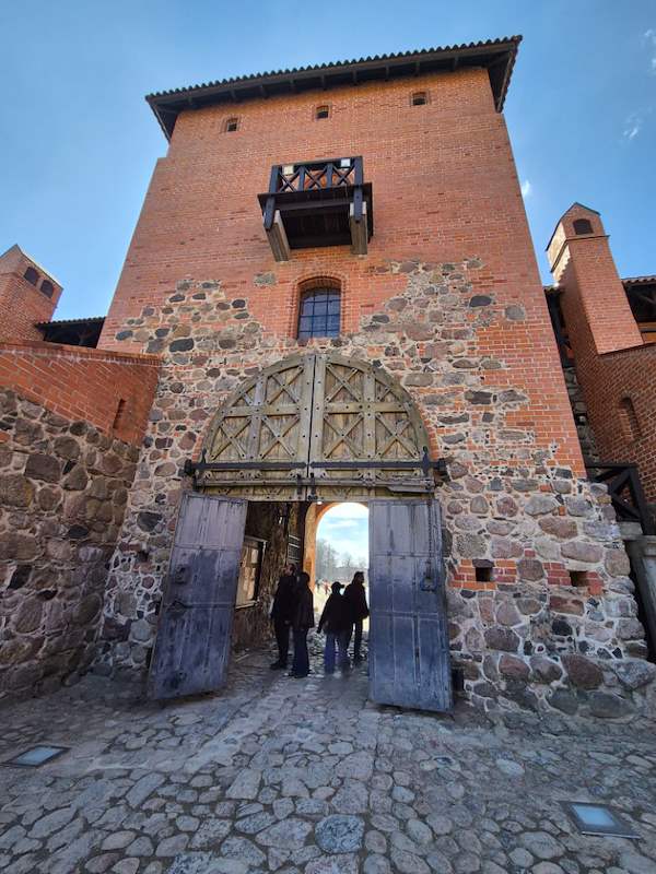 Trakai Castle day trip from Vilnius (2026) 3 Trakai Castle entrance gate with wooden doors.