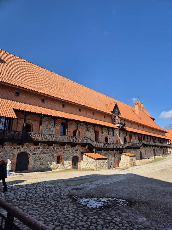 Trakai Castle day trip from Vilnius (2026) 5 Inside Trakai Castle courtyard buildings and walls.